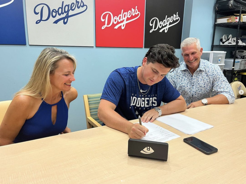 Jake Gelof signs a contract with the Los Angeles Dodgers. He’s flanked by his parents Kelly and Adam. SOURCE: JAKE GELOF INSTAGRAM